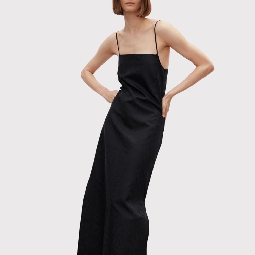 Brand new, never worn dress. Crafted from black-colored French Moir fabric.